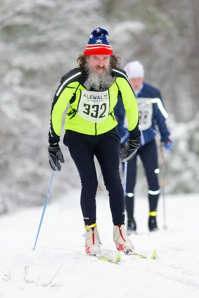 Bearded man at the event Ski Marathon in nordic skiing classic s