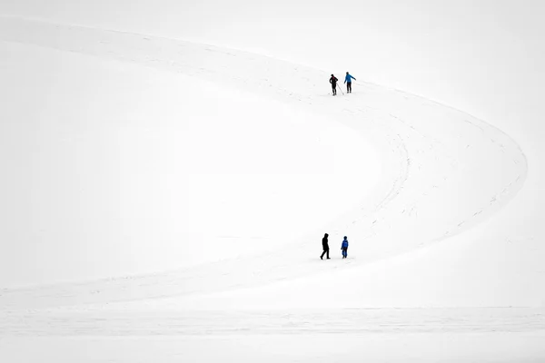 People walking on the frozen lake. Abstract