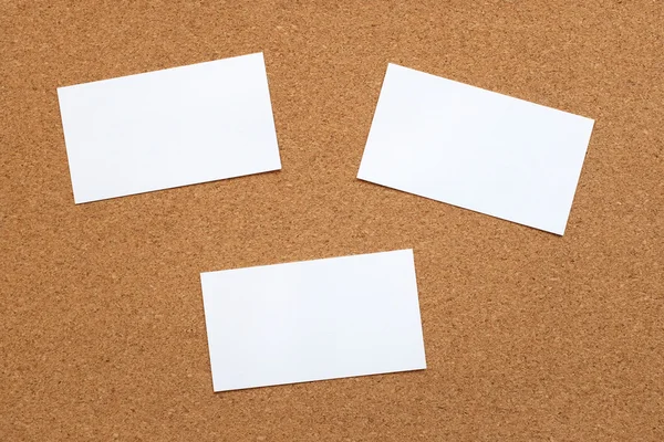 Three blank cards on a cork board