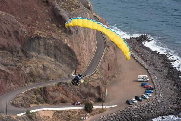 SANTA CRUZ DE TENERIFE, SPAIN - JANUARY 30: Breathtaking view of an unidentified pilot flying with a paraglider on January 30, 2016 in Santa Cruz de Tenerife, Tenerife, Spain.