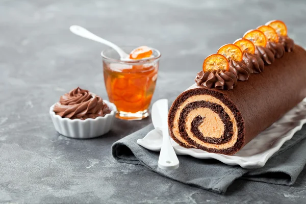 Chocolate swiss roll cake with candied kumquats
