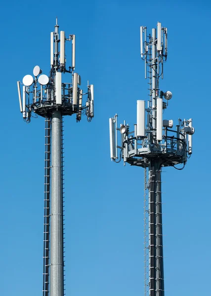Two telecommunications towers with satellites