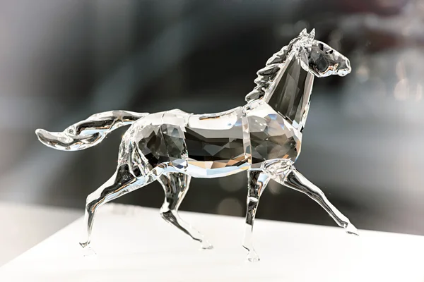 Trotting crystal horse with a flowing tail