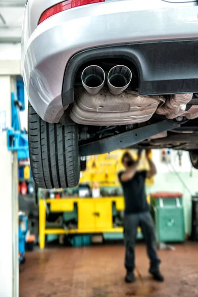 Mechanic repairing a motor car