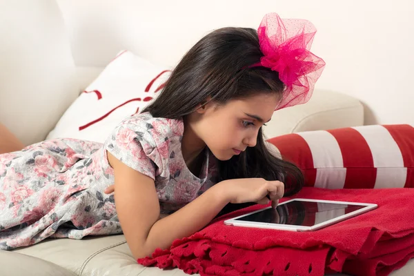 Young girl surfing the internet on a tablet
