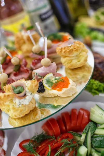 Decorated catering banquet table with different food snacks