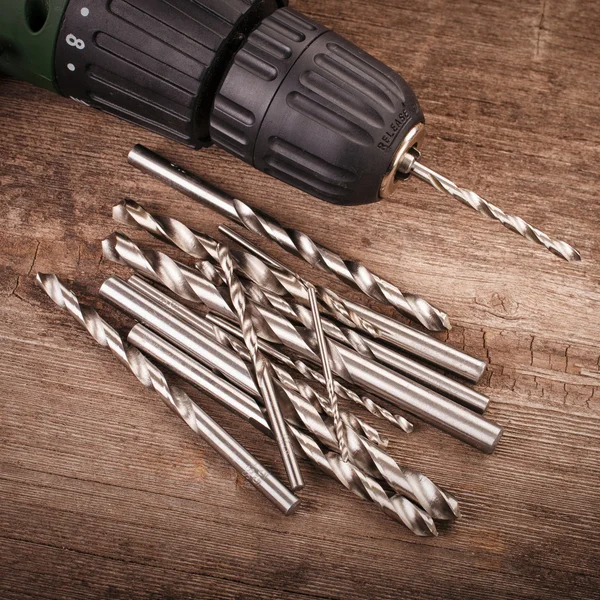 Drill and set of drill bits