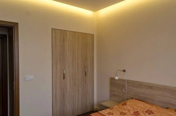 Bedroom in fresh renovated apartment with modern LED lighting