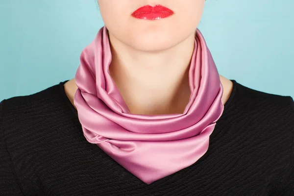 Silk scarf. Pink silk scarf around her neck isolated on white background.