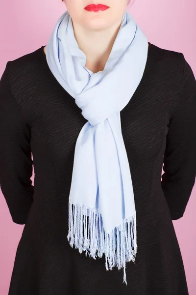 Silk scarf. Blue silk scarf around her neck isolated on pink background.