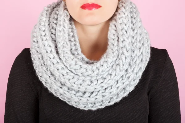 Silk scarf. Gray silk scarf around her neck isolated on pink background.