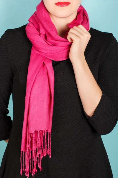 Silk scarf. Pink silk scarf around her neck isolated on blue background.