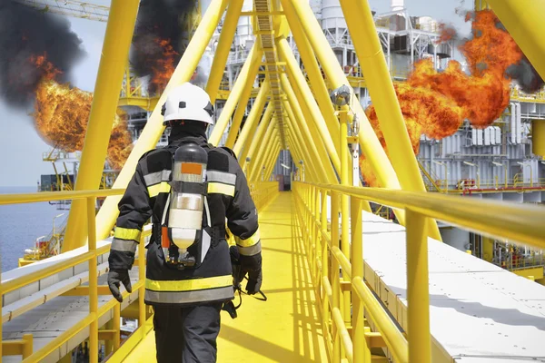 Fire fighter on oil and gas industry, successful firefighter at work , Fire suit for fighter with fire and suit for protect fire fighter, Security team when fire case.