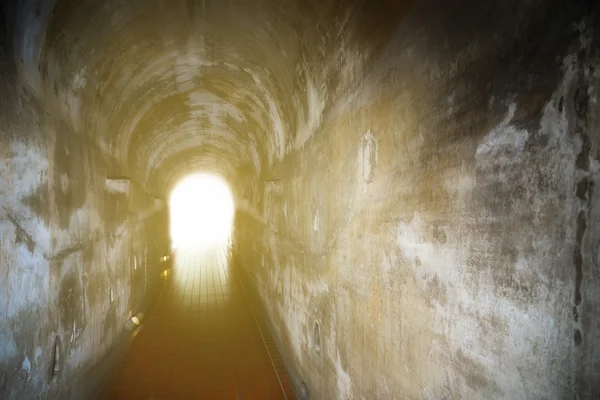 Tunnel background and business concept. tunnel with old brick. the end of tunnel and concept business successfully. mystery tunnel or mystery way. tunnel damaged and waited for repair.