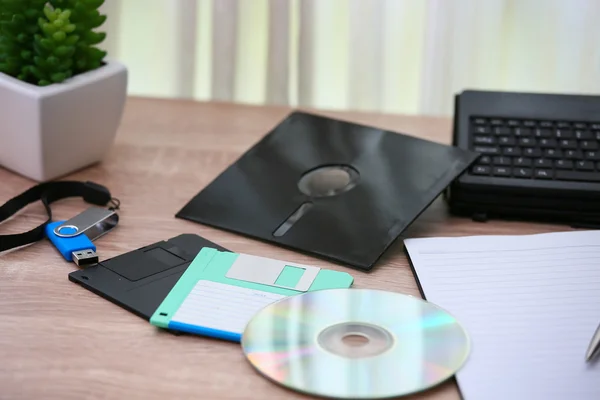 Desk with note ,floppy disk A, floppy disk B and memory drive in home office, private office and modern desk in modern life, online market and planning for work, document and paper on desk.