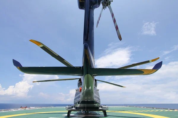 Helicopter parking landing on offshore platform. Helicopter transfer crews or passenger to work in offshore oil and gas industry.