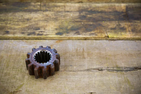 Old machine parts in machinery shop on wooden background.old machine with vintage picture style.