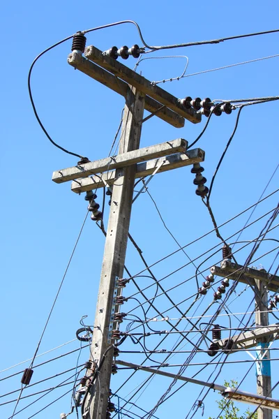 Electrical wire on pole. chaotic wire with nest on pole and blue sky background