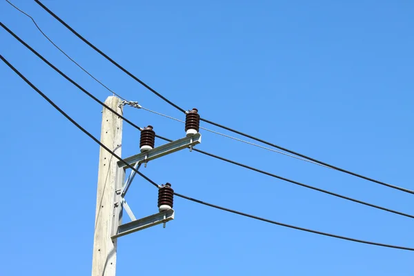 Electrical wire on pole. chaotic wire with nest on pole and blue sky background