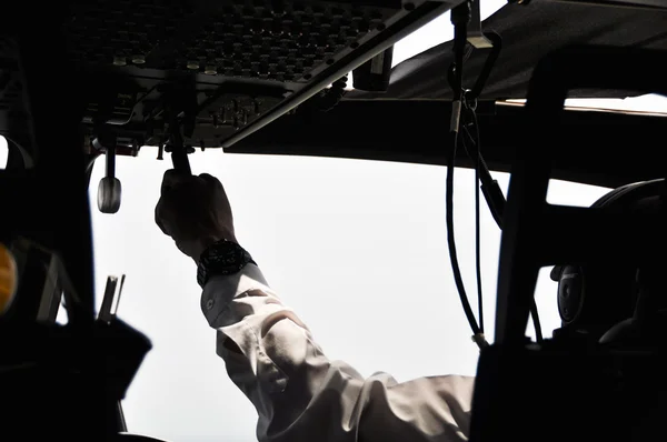 Pilot and copilot in corporate plane in cockpit, Pilot operation with control panel.