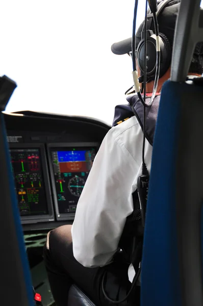 Pilot and copilot in corporate plane in cockpit, Pilot operation with control panel.