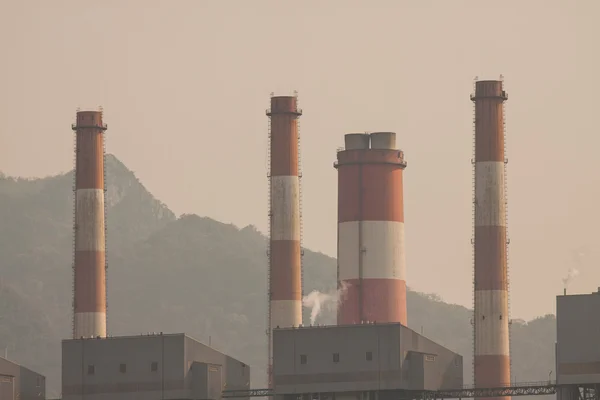 Industrial power plant with smokestack, the power plant production on hot condition in the mountain.