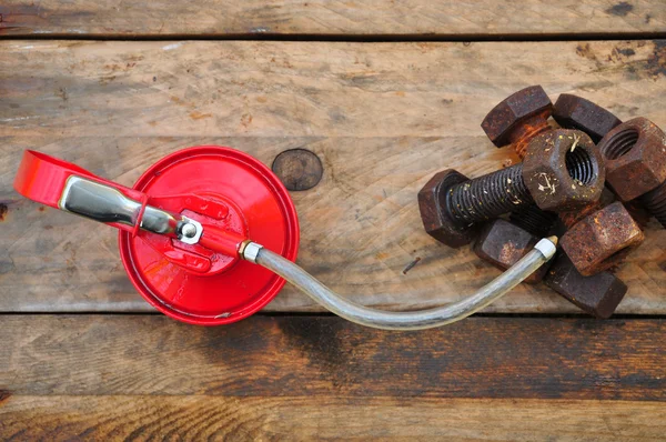 Oil can on wooden background, Lube oil can and used in industry or hard works.