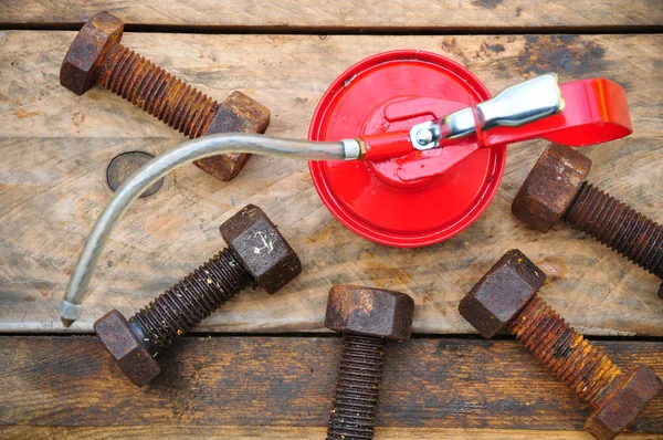 Oil can on wooden background, Lube oil can and used in industry or hard works.