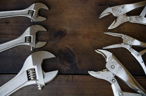 Adjustable wrench or spanner wrench and Locking pliers on wooden background, Prepare basic hand tools for work.