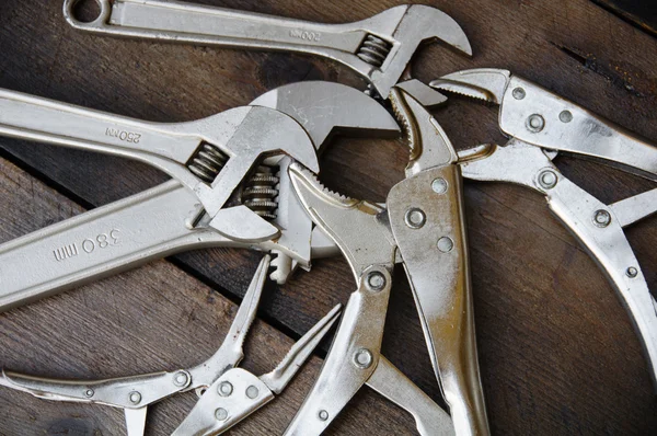 Adjustable wrench or spanner wrench and Locking pliers on wooden background, Prepare basic hand tools for work.