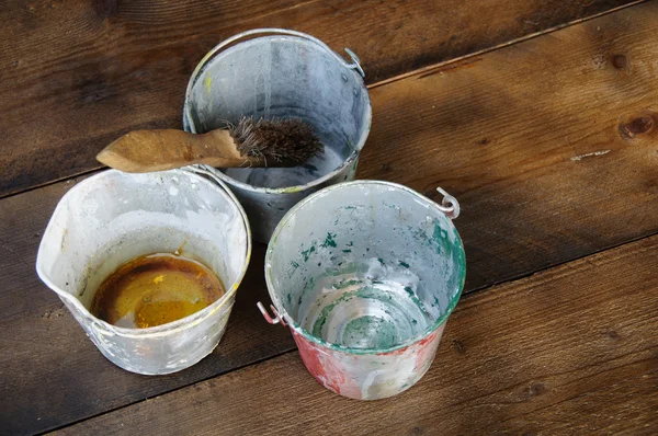 Paint cans or paint bucket on wooden background.