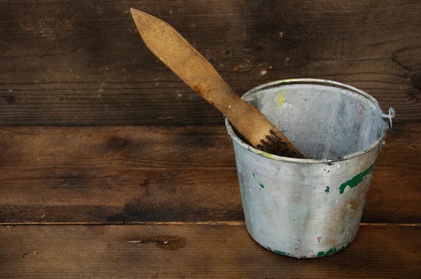 Paint cans or paint bucket on wooden background.