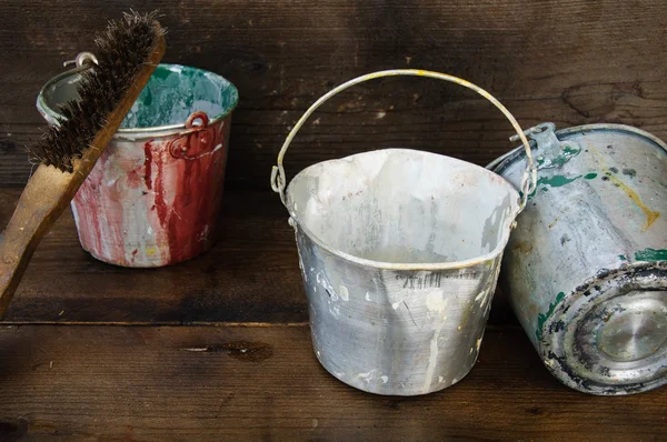 Paint cans or paint bucket on wooden background.