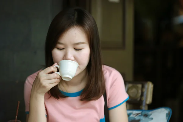 Asia women drinking coffee in cafe shop on free day, Relax time on cafe shop, Beautiful Girl Drinking Tea or Coffee in Cafe
