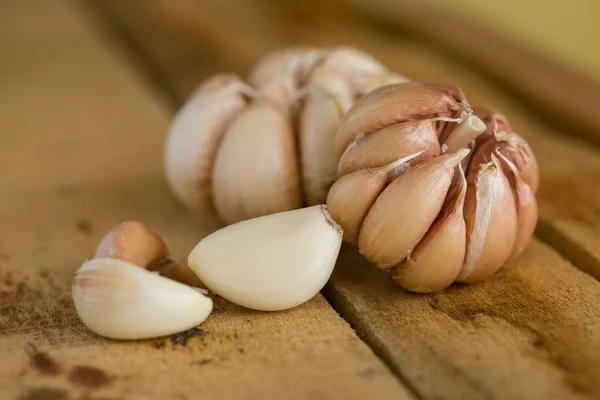 Garlic on the wooden background, Close up garlic on wooden table, Raw garlic in kitchen rooms.