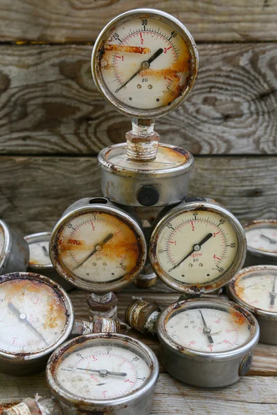 Old pressure gauge on wooden background and empty area for text, damage gauge from operation oil and gas production process.