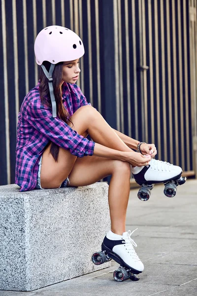Young woman wearing roller skating shoe outdoors lifestyle portrait