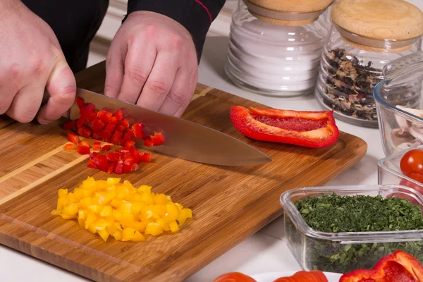 The chef cuts the peppers