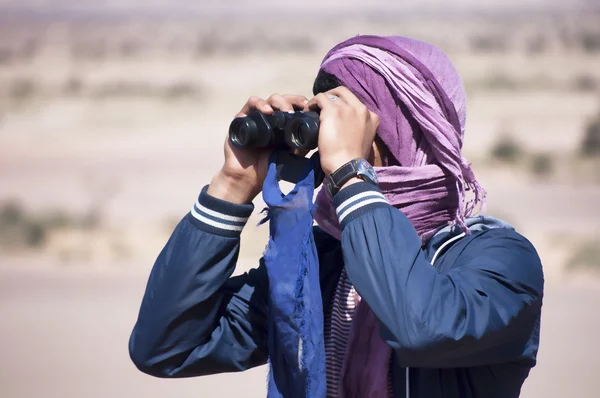 Man looking with binoculars