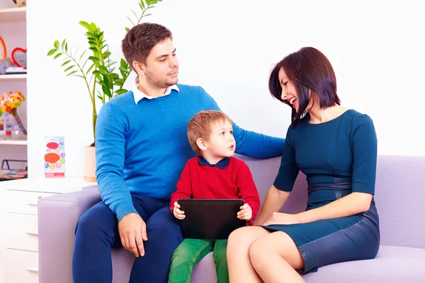 Kid with digital tablet talking to parents