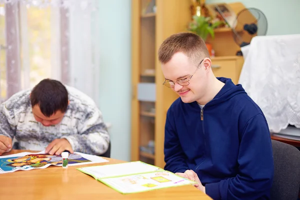 Young adult man engages in self study, in rehabilitation center