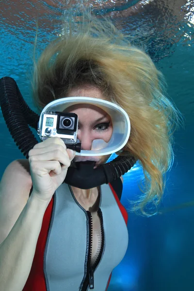 Female scuba diver with camera