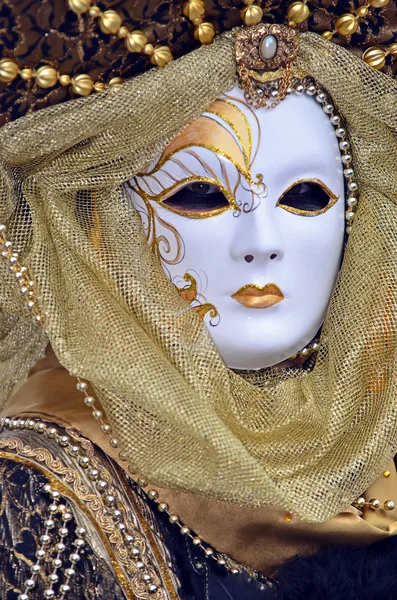 Carnival masked costume in gold