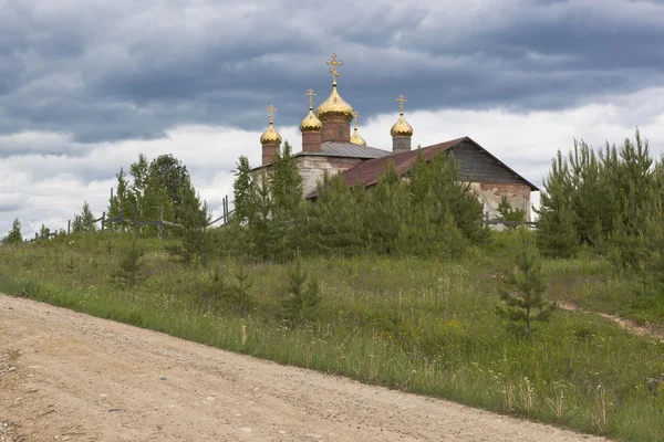 New domes on restorative church of St. Nicholas. Village Average (Olyushin) Verhovazhskogo district, Vologda region, Russia