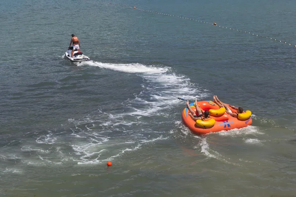 Riding on an inflatable raft on the water surface of the sea. Beach activities in bay of Gelendzhik, Krasnodar region, Russia