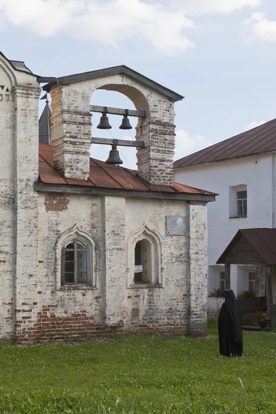 The priest rings bells of hospital church Euphemia of the Grand in Kirillo-Belozersky Monastery