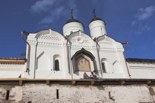 Restoration work on the Gate Church of Transfiguration of Our Lord in Kirillo-Belozersky Monastery. Workers perform roofing work