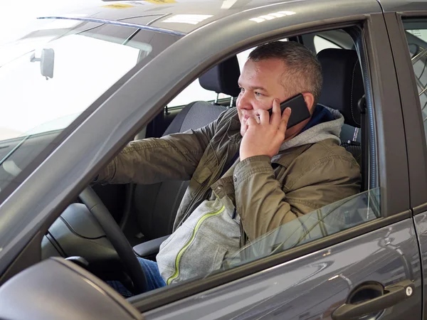 Young fat man behind wheel