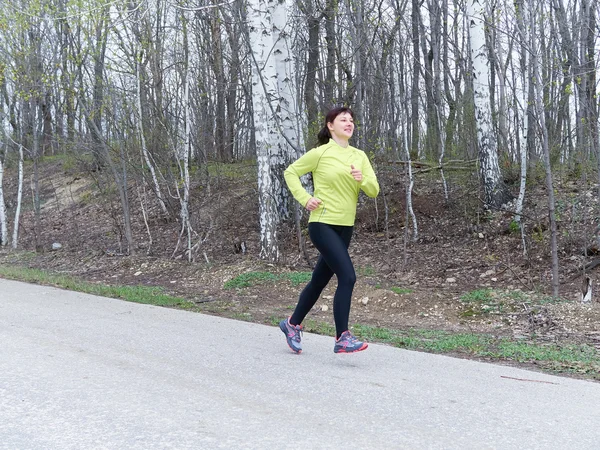 Young woman running in nature.