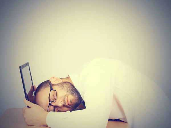 Portrait  of tired businessman sleeping on his laptop